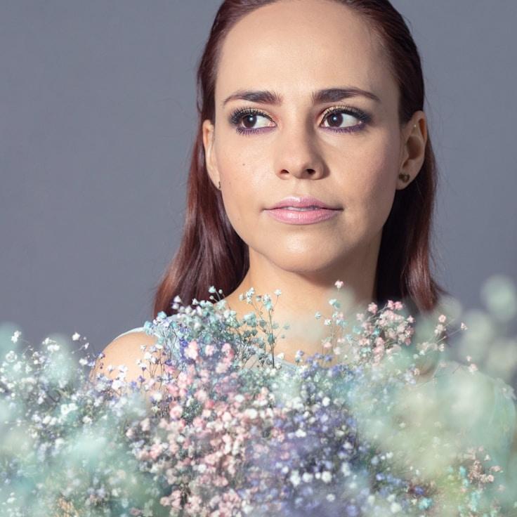 Kaveri Mehta, Lead Design Curator at HumbleGroveWing, reviewing corporate floral arrangements